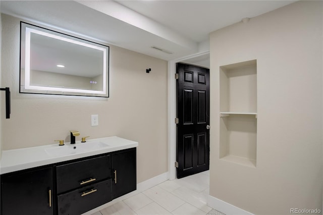 bathroom with visible vents, vanity, and baseboards