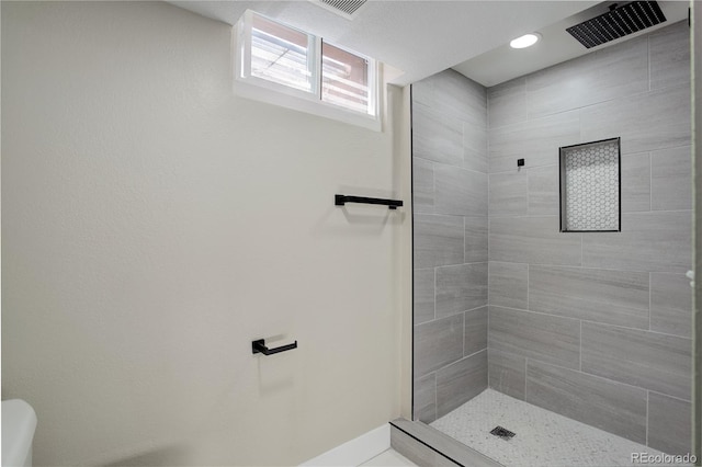 full bathroom featuring visible vents and tiled shower