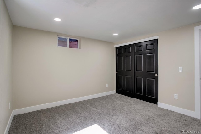 unfurnished bedroom featuring carpet flooring, recessed lighting, baseboards, and a closet