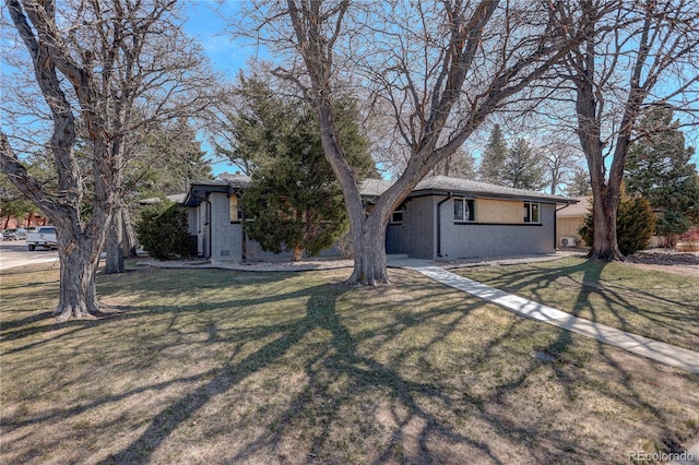 single story home featuring a front yard and brick siding