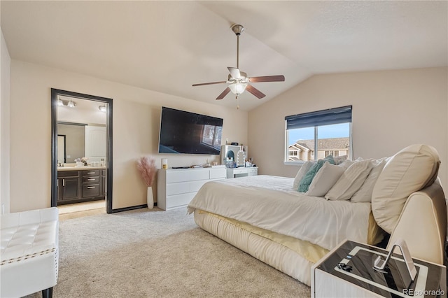 carpeted bedroom featuring ceiling fan, lofted ceiling, and connected bathroom