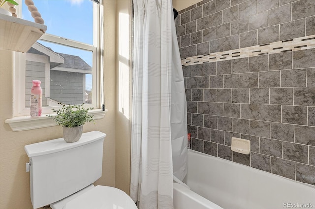 bathroom with shower / bath combination with curtain and toilet