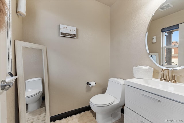 bathroom featuring vanity and toilet