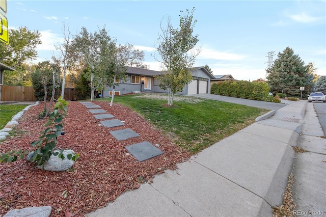 single story home featuring a front lawn and a garage