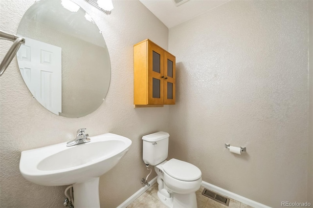 bathroom with tile patterned floors, toilet, and sink