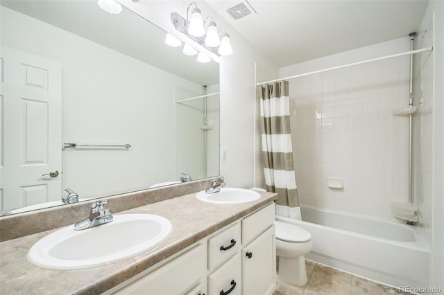 full bathroom featuring tile patterned flooring, vanity, toilet, and shower / bath combo with shower curtain