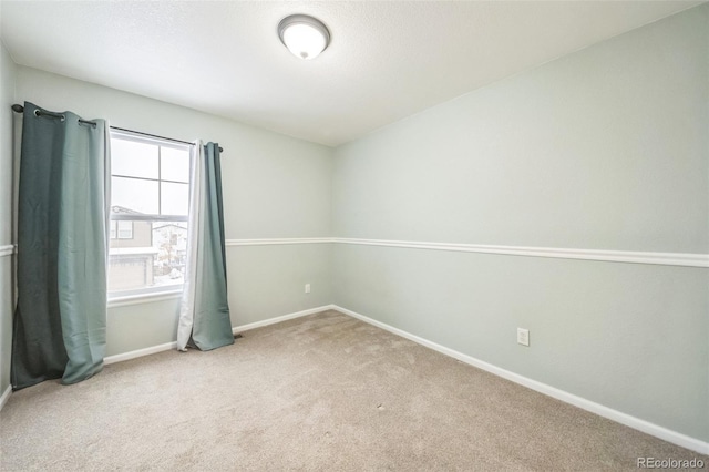 spare room with light colored carpet