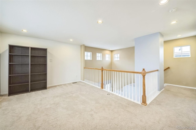 basement featuring light colored carpet