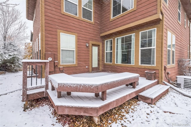 snow covered deck featuring central air condition unit