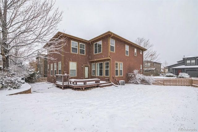 snow covered house featuring a deck and central air condition unit