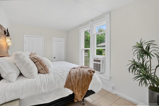 274 S Lincoln St, Denver, CO 80209 - bedroom featuring light tile patterned floors, cooling unit, and two closets