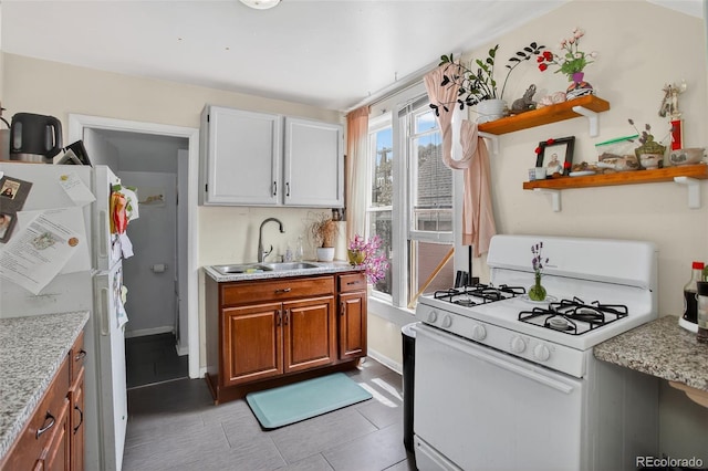 274 S Lincoln St, Denver, CO 80209 - kitchen featuring white appliances, light tile patterned flooring, brown cabinetry, open shelves, and light stone countertops