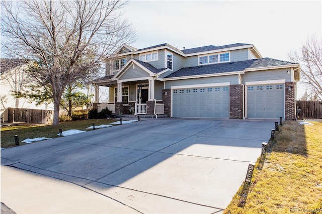 view of front of home featuring a porch, a garage, and a front yard