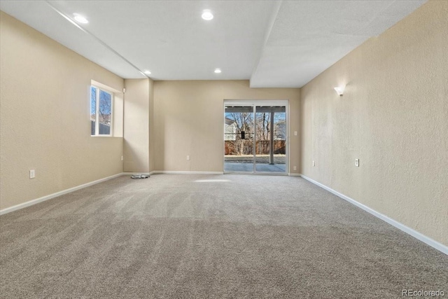 empty room featuring recessed lighting, baseboards, carpet floors, and a textured wall