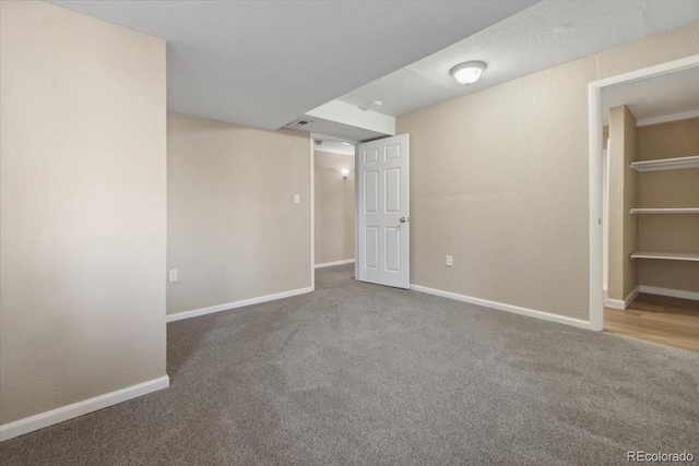 interior space with carpet and baseboards