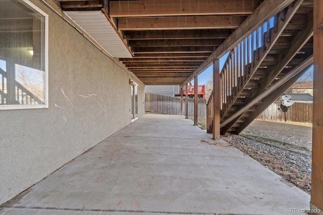 view of patio with stairway and fence