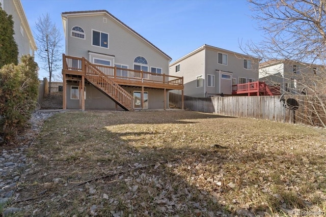 rear view of house featuring a deck, stairs, and fence private yard