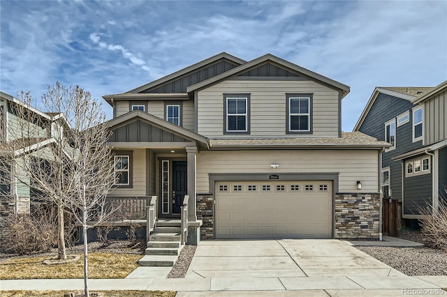 craftsman house with board and batten siding, concrete driveway, an attached garage, and stone siding