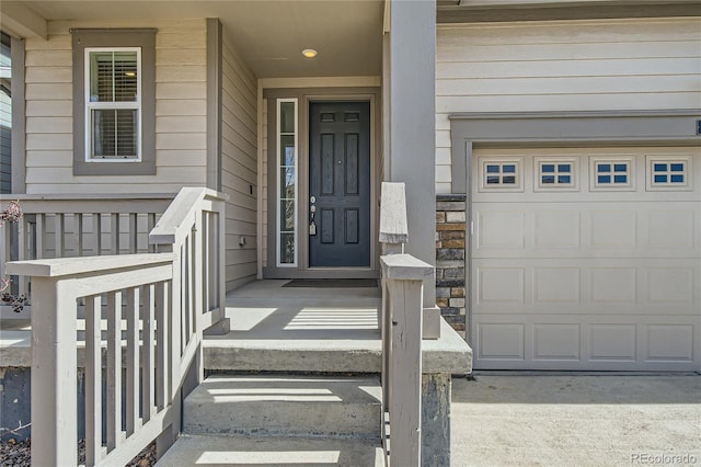 property entrance with a garage and stone siding