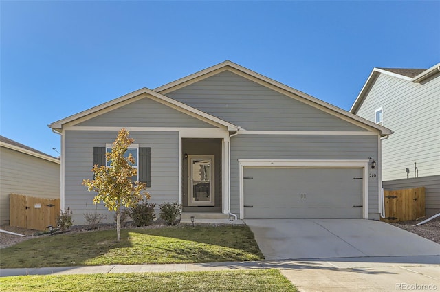 view of front of house featuring a garage and a front yard