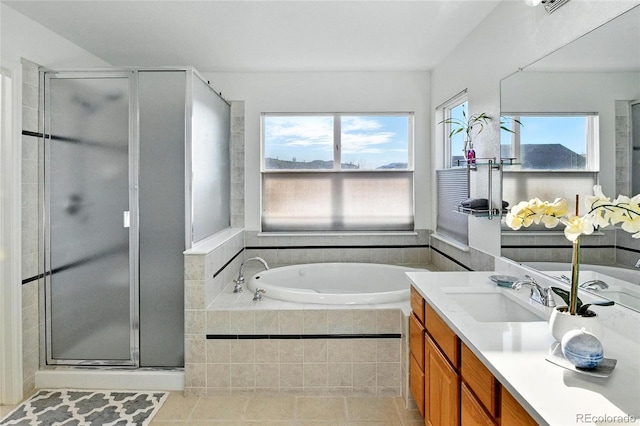 bathroom featuring a garden tub, a stall shower, tile patterned floors, and vanity