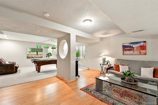 living room featuring a textured ceiling, baseboards, billiards, wood finished floors, and visible vents