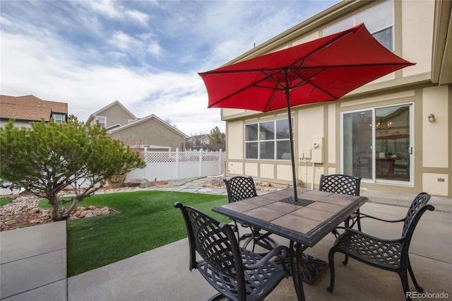 view of patio / terrace featuring fence and outdoor dining area