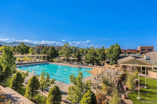 pool featuring a mountain view and a patio area