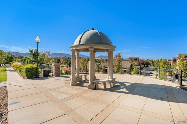 view of patio / terrace featuring a mountain view and fence