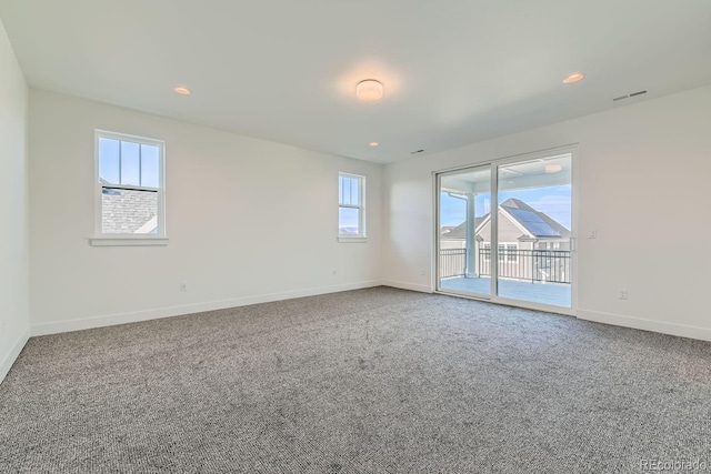 unfurnished room with recessed lighting, carpet, visible vents, and baseboards