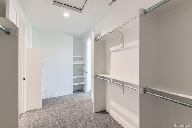 walk in closet with light carpet and visible vents