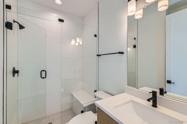 bathroom with a shower stall, toilet, and vanity