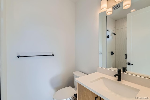 full bath featuring visible vents, vanity, toilet, and a shower stall