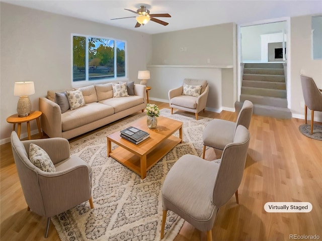 living room with ceiling fan and light hardwood / wood-style flooring