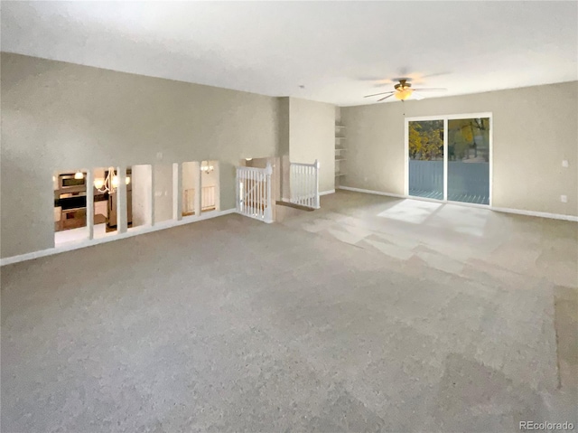 unfurnished living room featuring carpet and ceiling fan