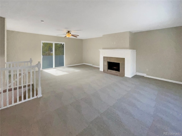 unfurnished living room featuring ceiling fan and carpet flooring