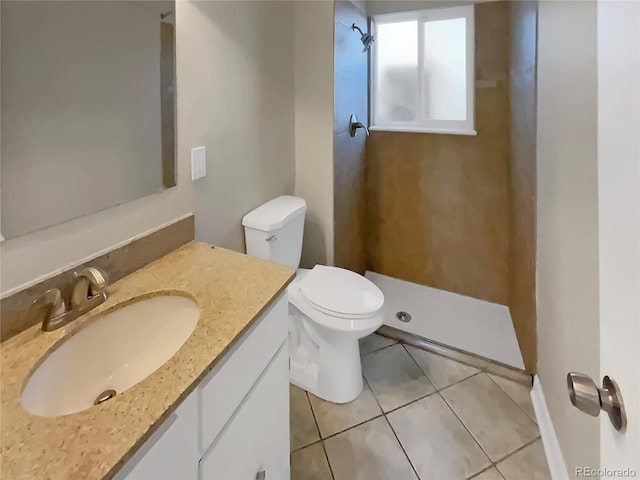 bathroom with toilet, walk in shower, vanity, and tile patterned floors