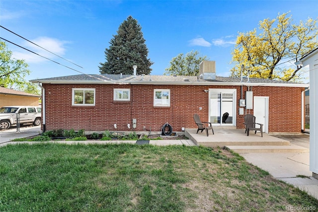 6506 Lee St, Arvada, CO 80004 - rear view of property with a yard, brick siding, a patio, and a chimney