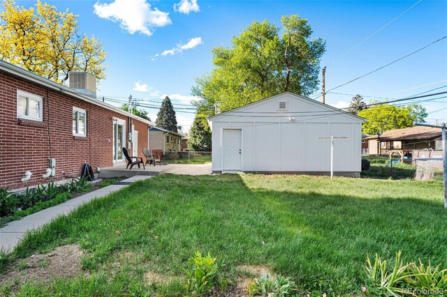 6506 Lee St, Arvada, CO 80004 - view of green lawn with a patio and an outbuilding