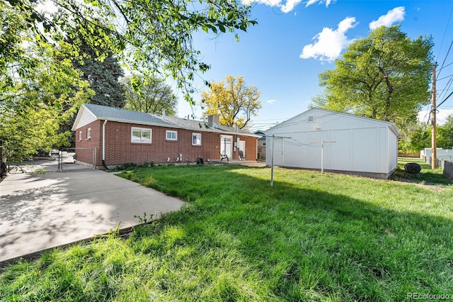 6506 Lee St, Arvada, CO 80004 - rear view of house featuring brick siding, a gate, and a chimney