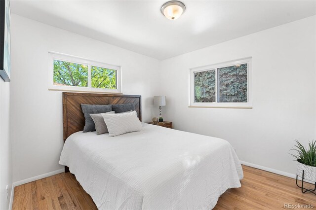 6506 Lee St, Arvada, CO 80004 - bedroom featuring baseboards and wood finished floors