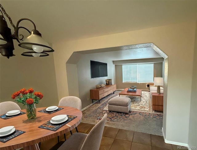 dining space with dark tile patterned floors