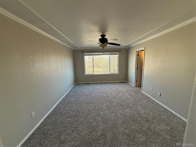 carpeted spare room with a textured ceiling, ceiling fan, and crown molding