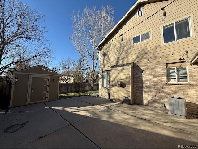 view of home's exterior with a patio area, cooling unit, and a storage shed