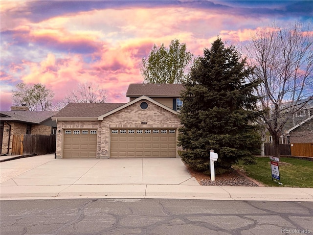13031 Dexter St, Thornton, CO 80241 - view of front of house featuring a garage, driveway, brick siding, and roof with shingles
