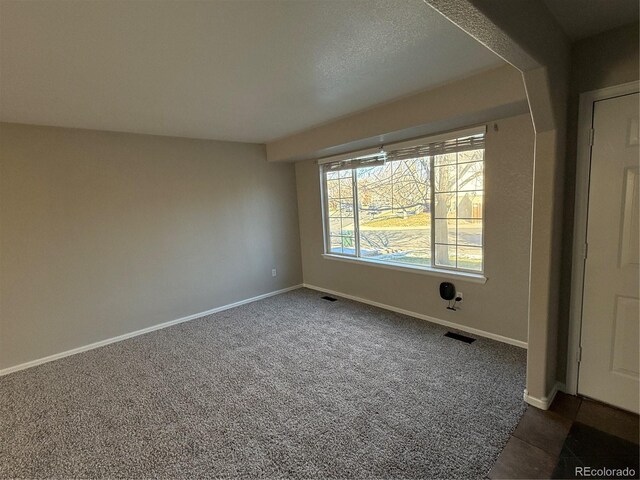 13031 Dexter St, Thornton, CO 80241 - unfurnished room with baseboards and dark carpet