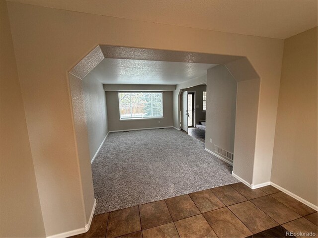 13031 Dexter St, Thornton, CO 80241 - bonus room with arched walkways, carpet floors, baseboards, and tile patterned floors