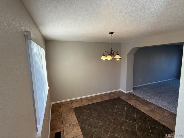 13031 Dexter St, Thornton, CO 80241 - tiled spare room featuring a chandelier and a textured ceiling
