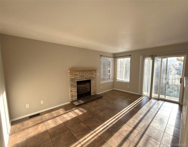 13031 Dexter St, Thornton, CO 80241 - unfurnished living room featuring baseboards, tile patterned flooring, and a fireplace