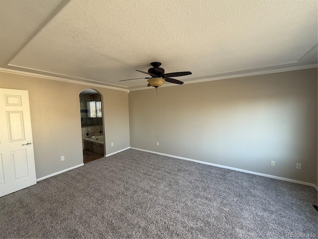 13031 Dexter St, Thornton, CO 80241 - spare room featuring ceiling fan, ornamental molding, dark carpet, arched walkways, and a textured ceiling